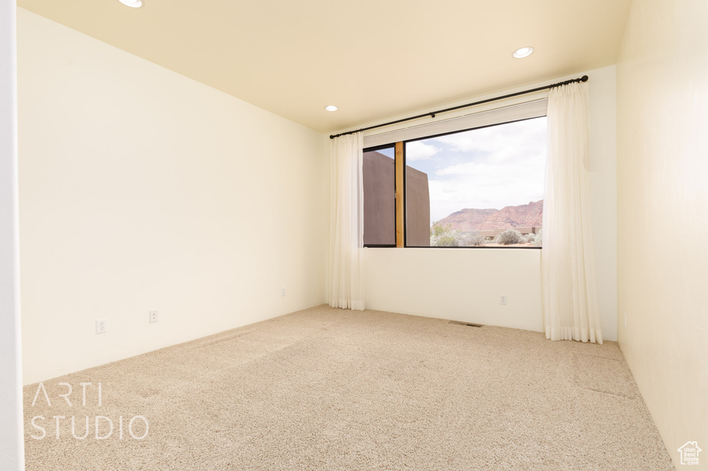 Unfurnished room featuring recessed lighting and carpet