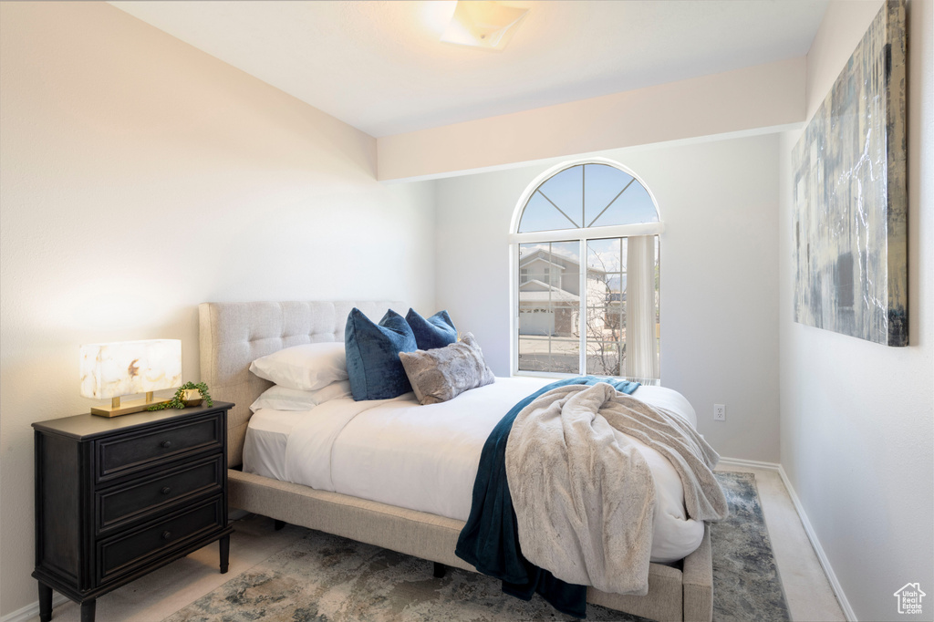 Carpeted bedroom featuring baseboards