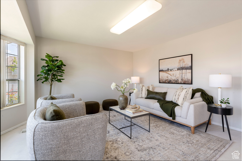 Carpeted living room with baseboards
