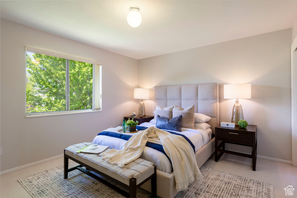 Carpeted bedroom featuring baseboards