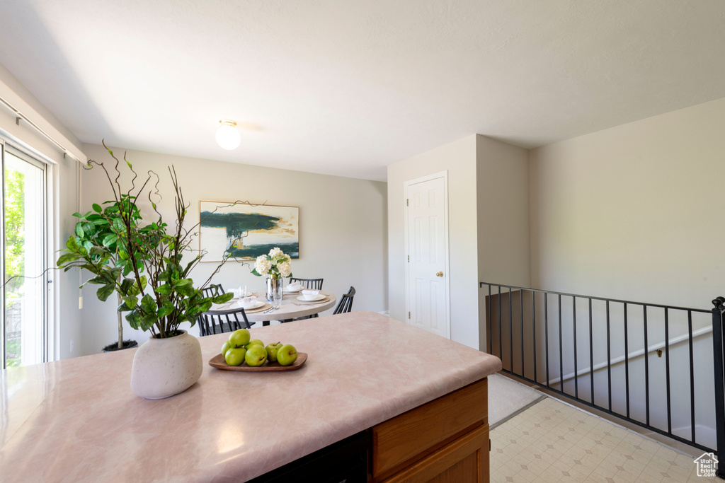 Kitchen with light countertops, brown cabinetry, and light floors