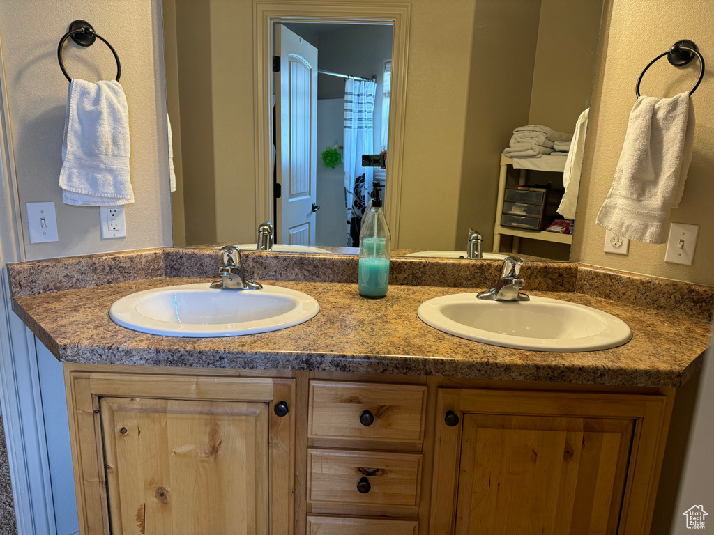 Full bath featuring a sink and double vanity