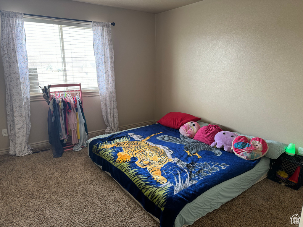 Bedroom with carpet floors and baseboards