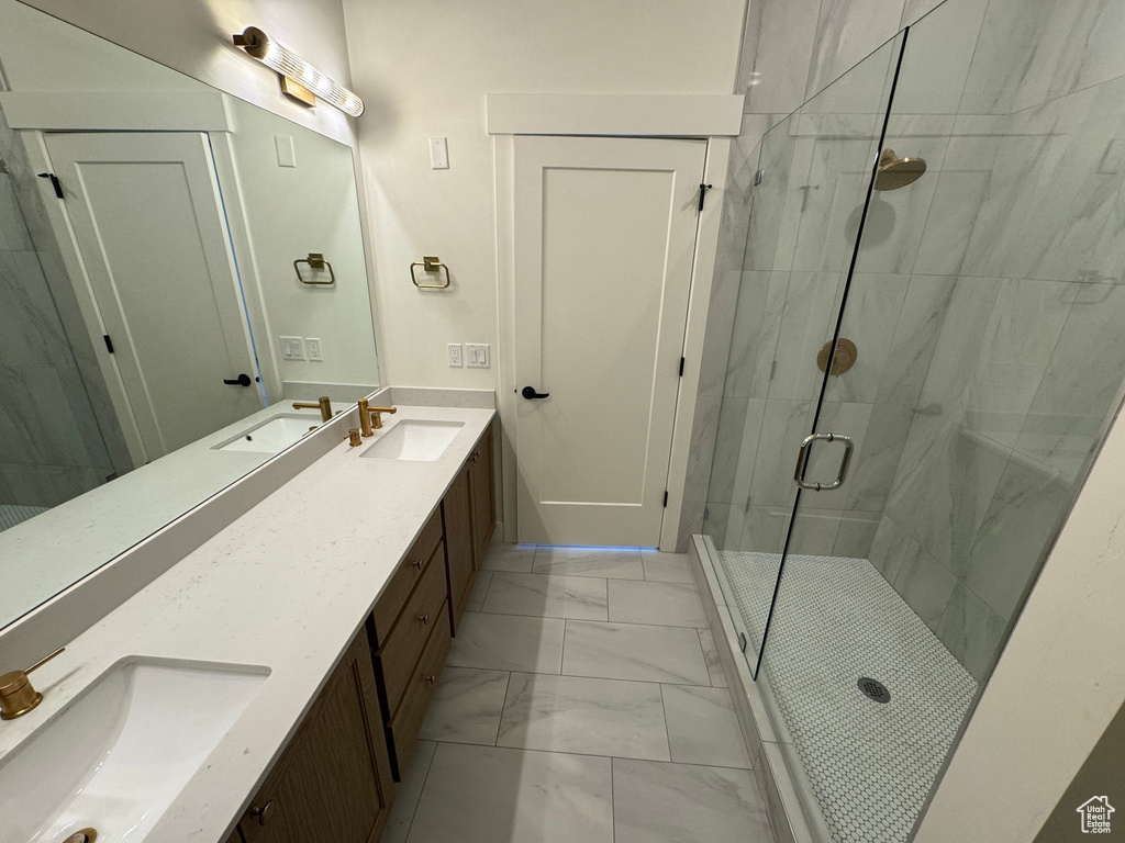 Full bath with a sink, a stall shower, and marble finish floor