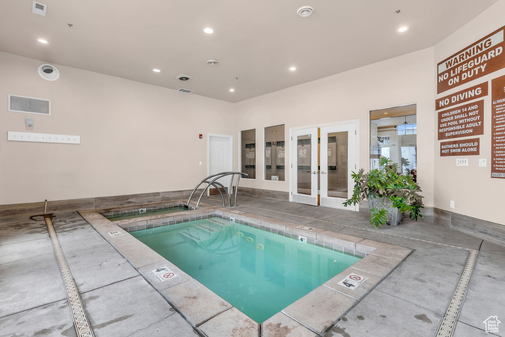 View of swimming pool with french doors and a swimming pool