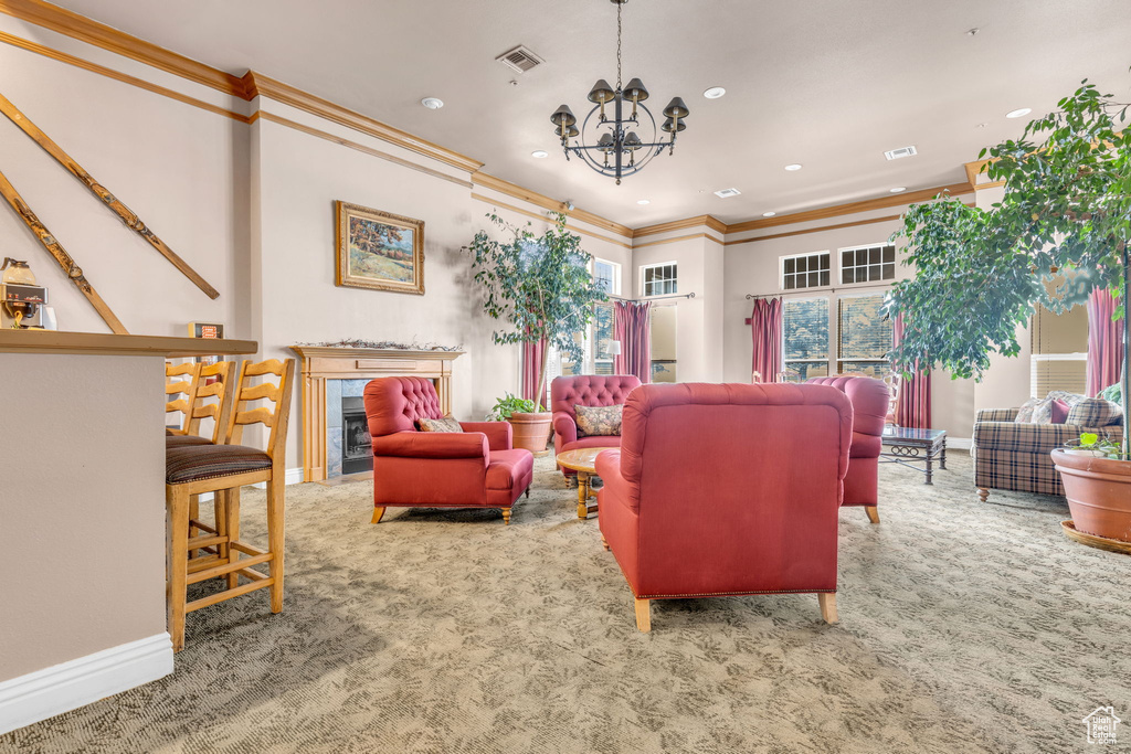 Living area with visible vents, a notable chandelier, ornamental molding, carpet flooring, and recessed lighting
