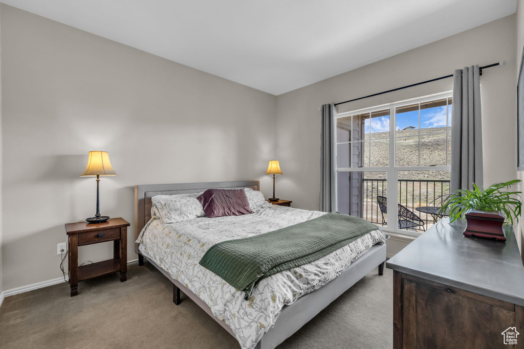 Bedroom featuring light colored carpet and baseboards