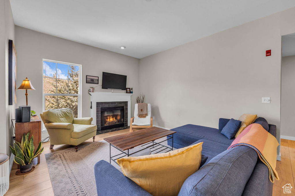 Living area featuring recessed lighting, wood finished floors, and a fireplace