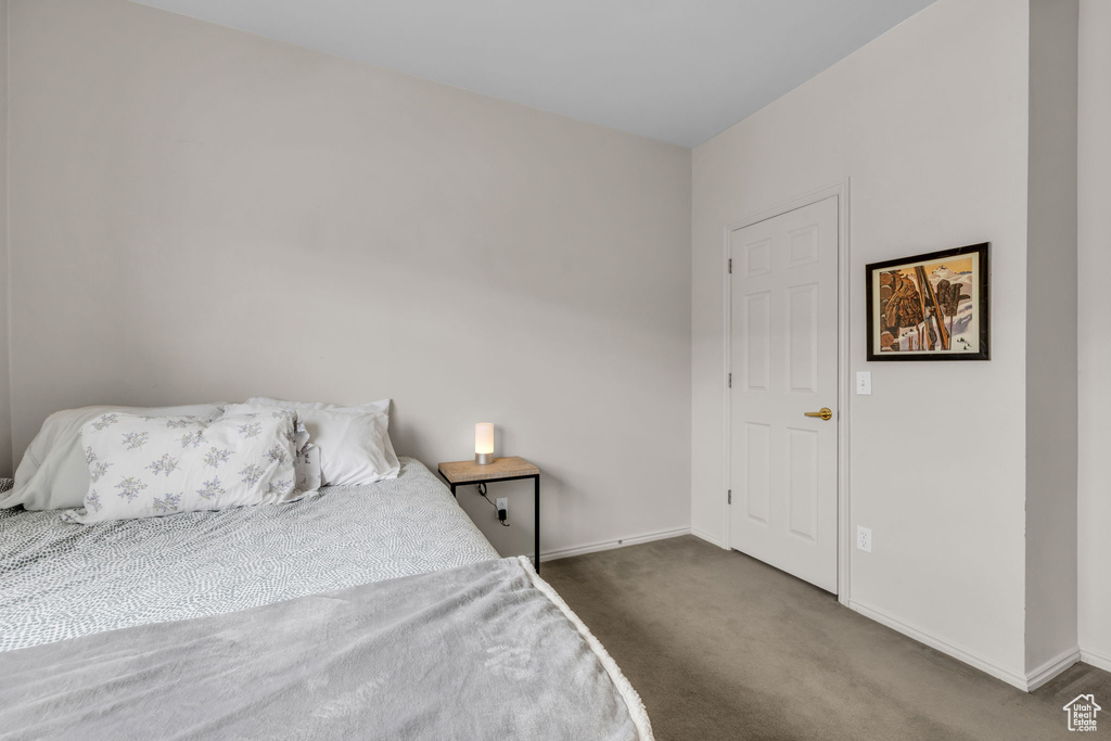 Carpeted bedroom featuring baseboards