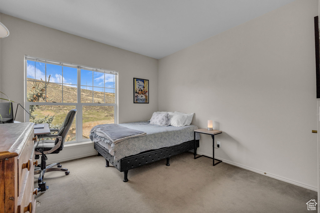 Carpeted bedroom featuring baseboards