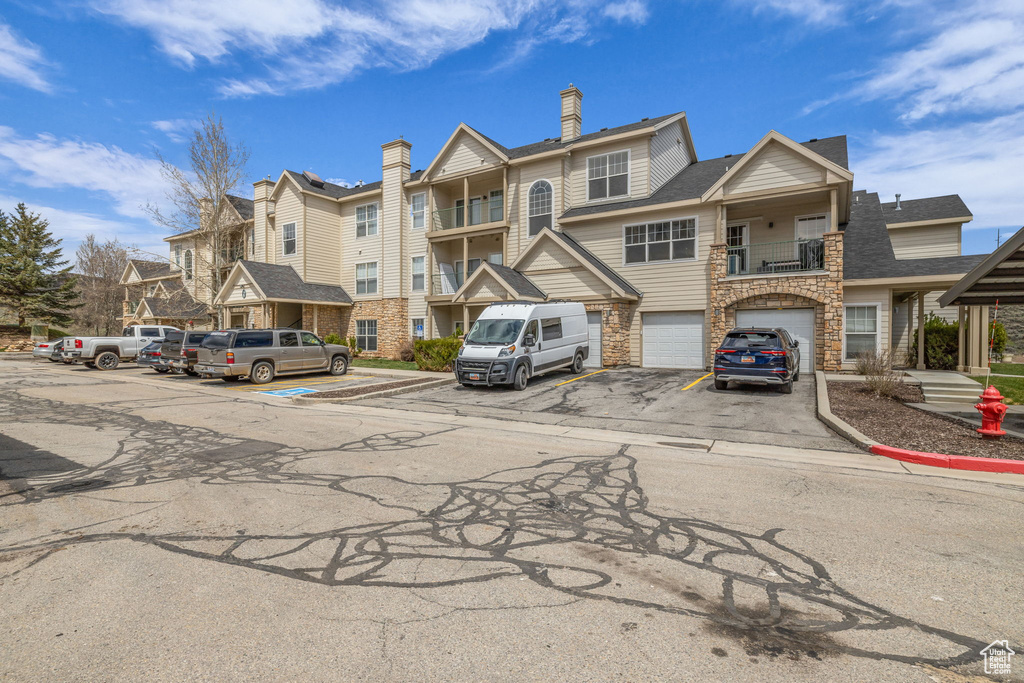 View of property featuring a residential view and a garage