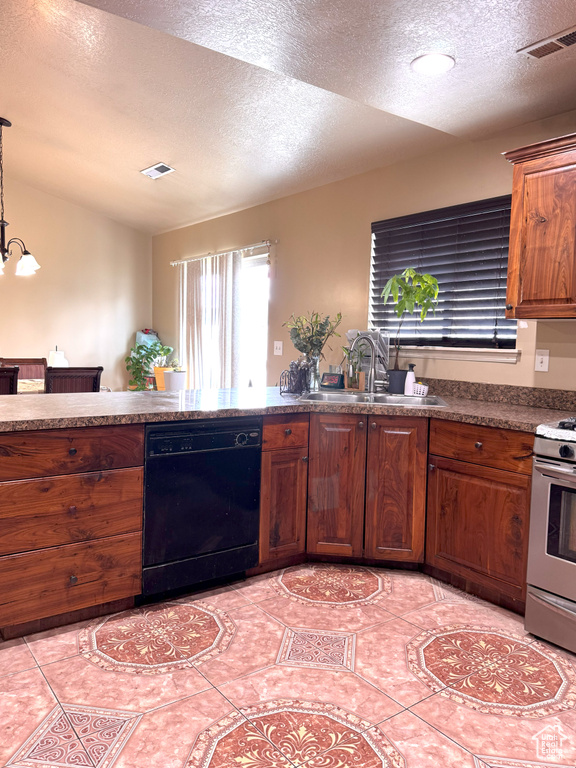 Kitchen featuring black dishwasher, visible vents, stainless steel range with gas stovetop, and a sink