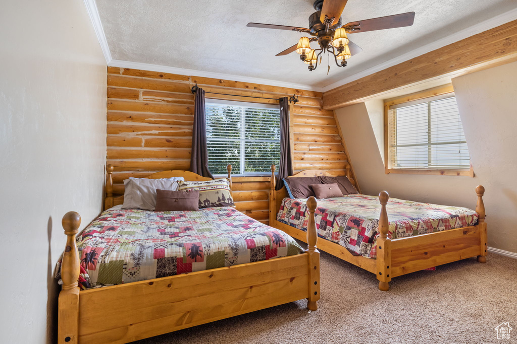 Bedroom featuring carpet flooring, a ceiling fan, baseboards, rustic walls, and ornamental molding