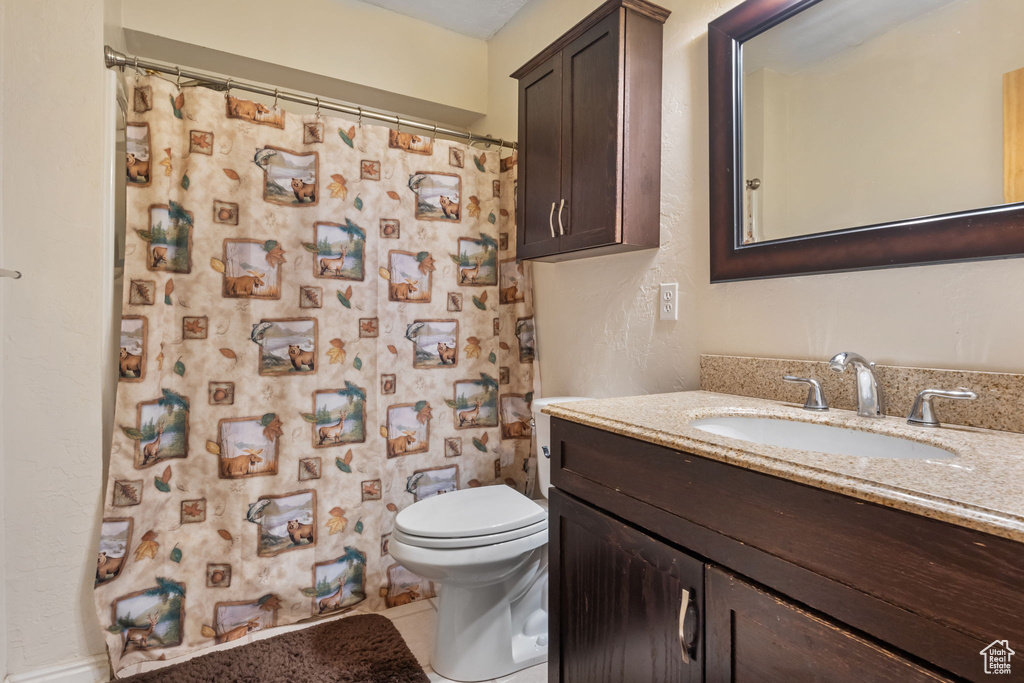 Full bath featuring vanity, tile patterned floors, a shower with curtain, and toilet