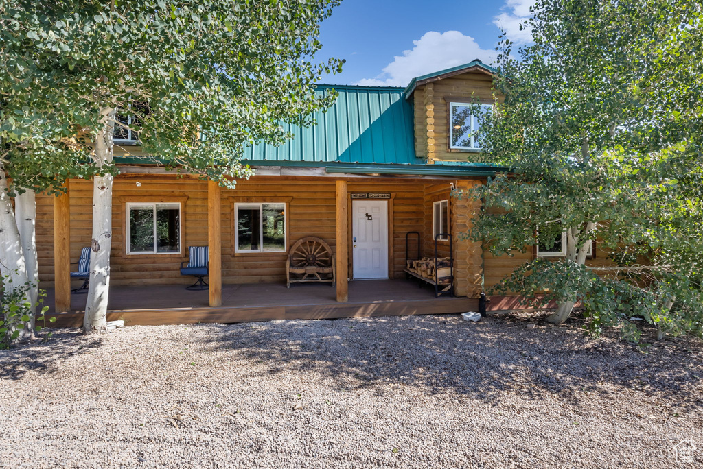 View of front facade with a porch and metal roof
