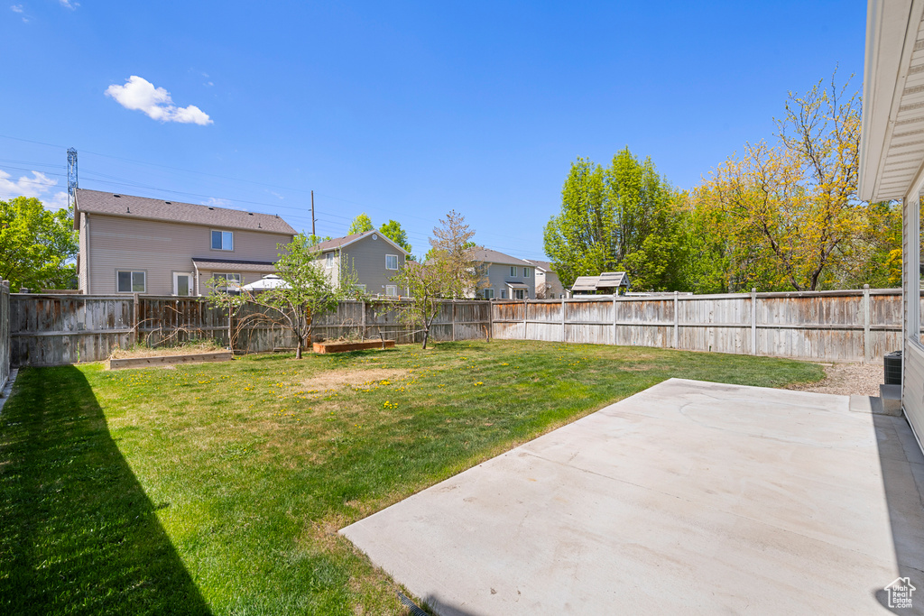 View of yard with a residential view, a fenced backyard, and a patio area
