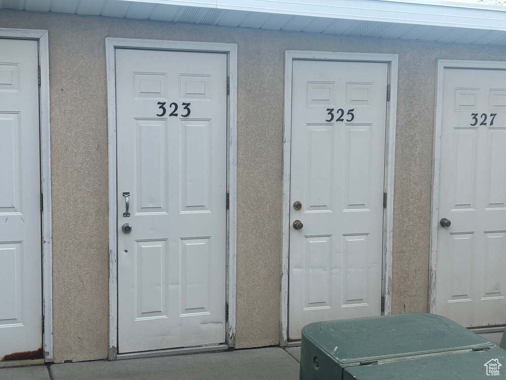 View of exterior entry featuring stucco siding