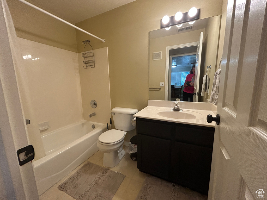 Bathroom featuring tub / shower combination, vanity, toilet, and visible vents