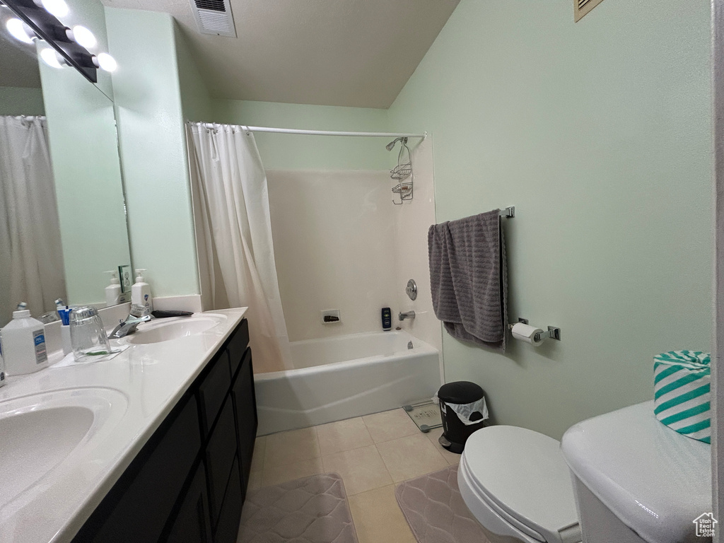 Bathroom featuring a sink, tile patterned floors, toilet, and visible vents