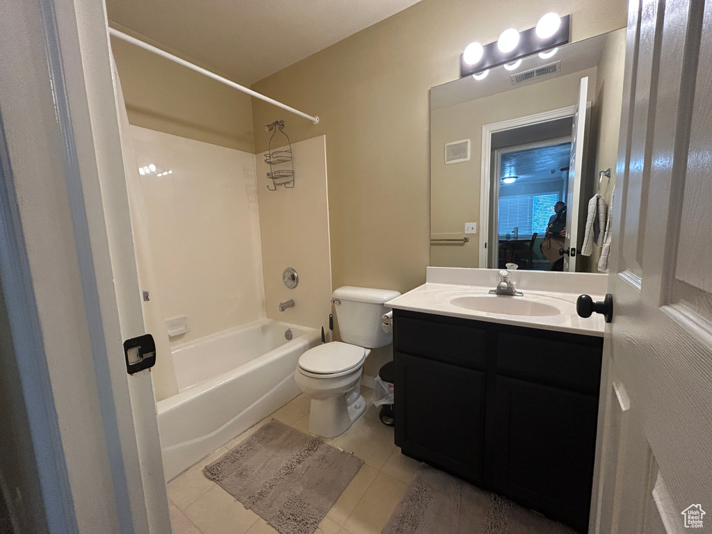 Full bath with toilet, visible vents, tile patterned flooring, and vanity