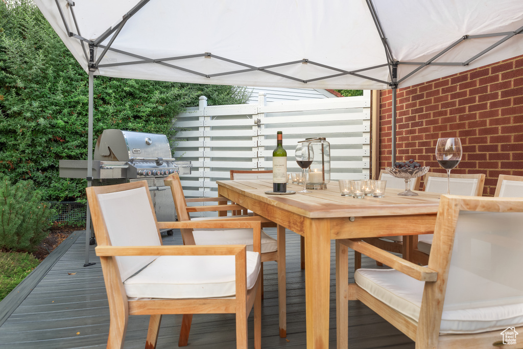 Wooden deck featuring outdoor dining space