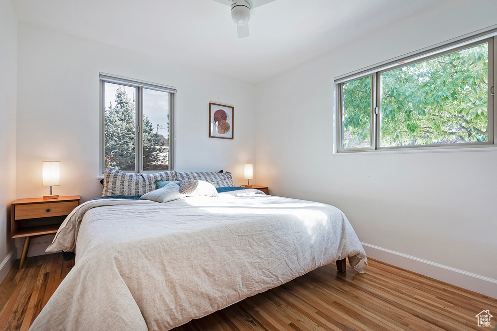 Bedroom featuring baseboards, ceiling fan, and wood finished floors