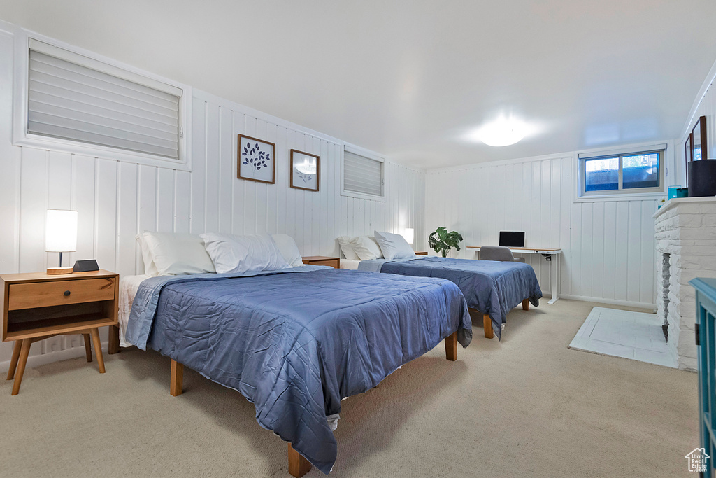 Carpeted bedroom with a fireplace