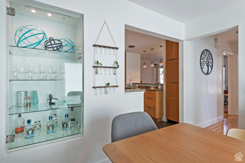 Bar featuring baseboards, recessed lighting, and wood finished floors