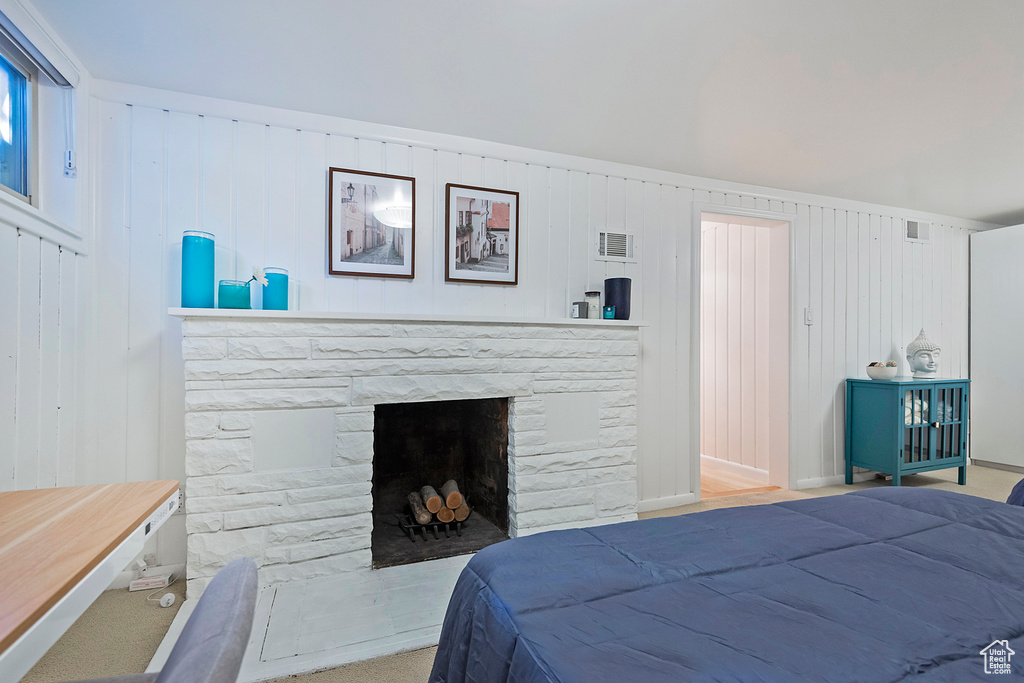 Bedroom with visible vents and a fireplace