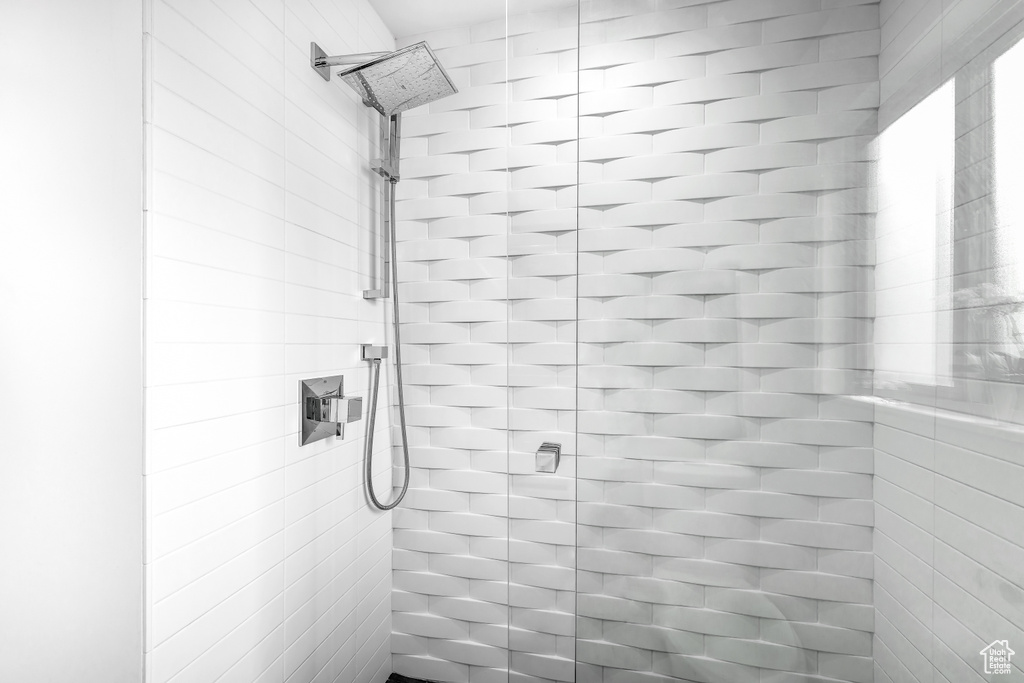 Full bath featuring tiled shower