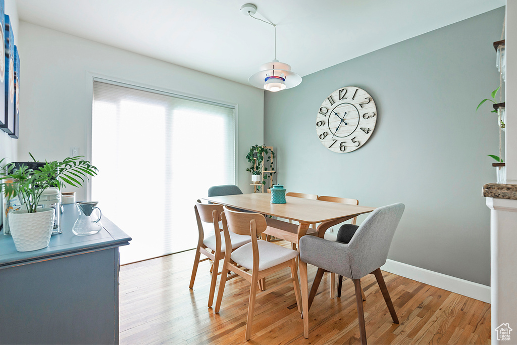 Dining space with light wood-style floors and baseboards