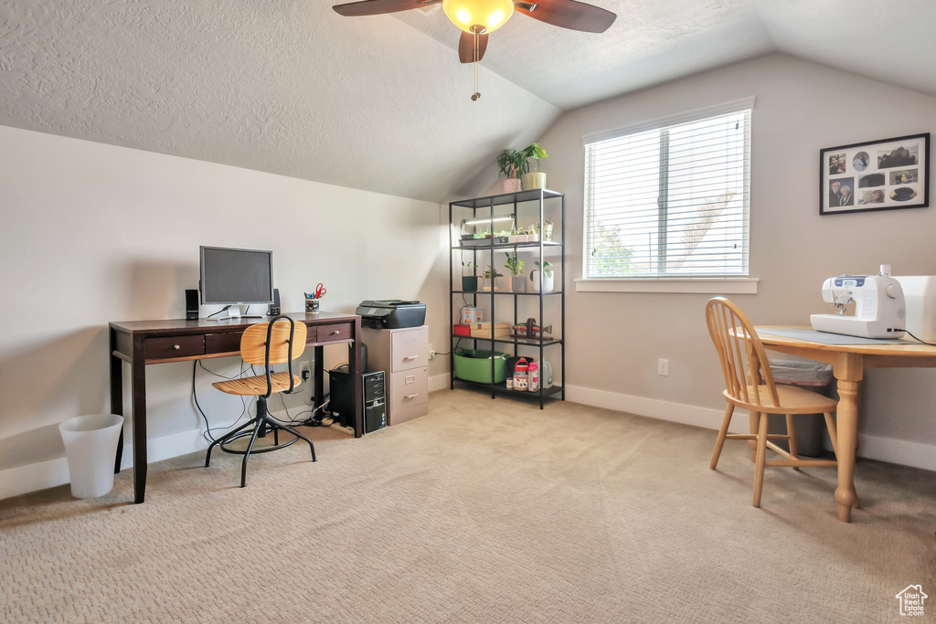 Carpeted home office with baseboards, a ceiling fan, a textured ceiling, and lofted ceiling