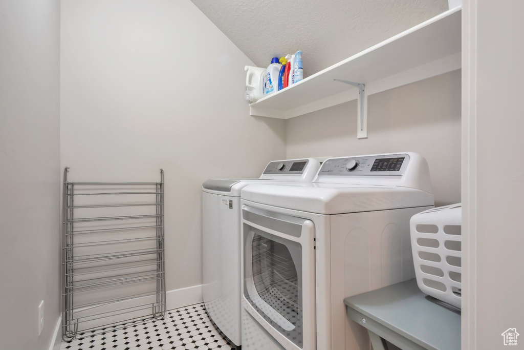 Laundry room featuring baseboards, laundry area, and washer and dryer