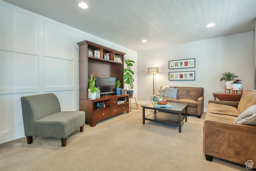 Living room with recessed lighting and light colored carpet
