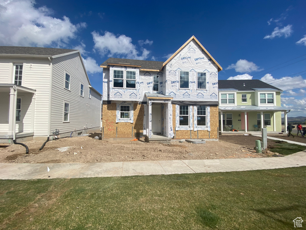 Property in mid-construction featuring brick siding and a front yard