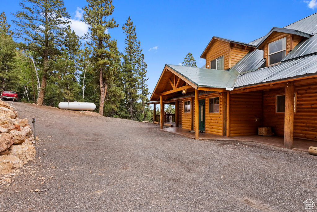 View of property exterior with faux log siding and metal roof