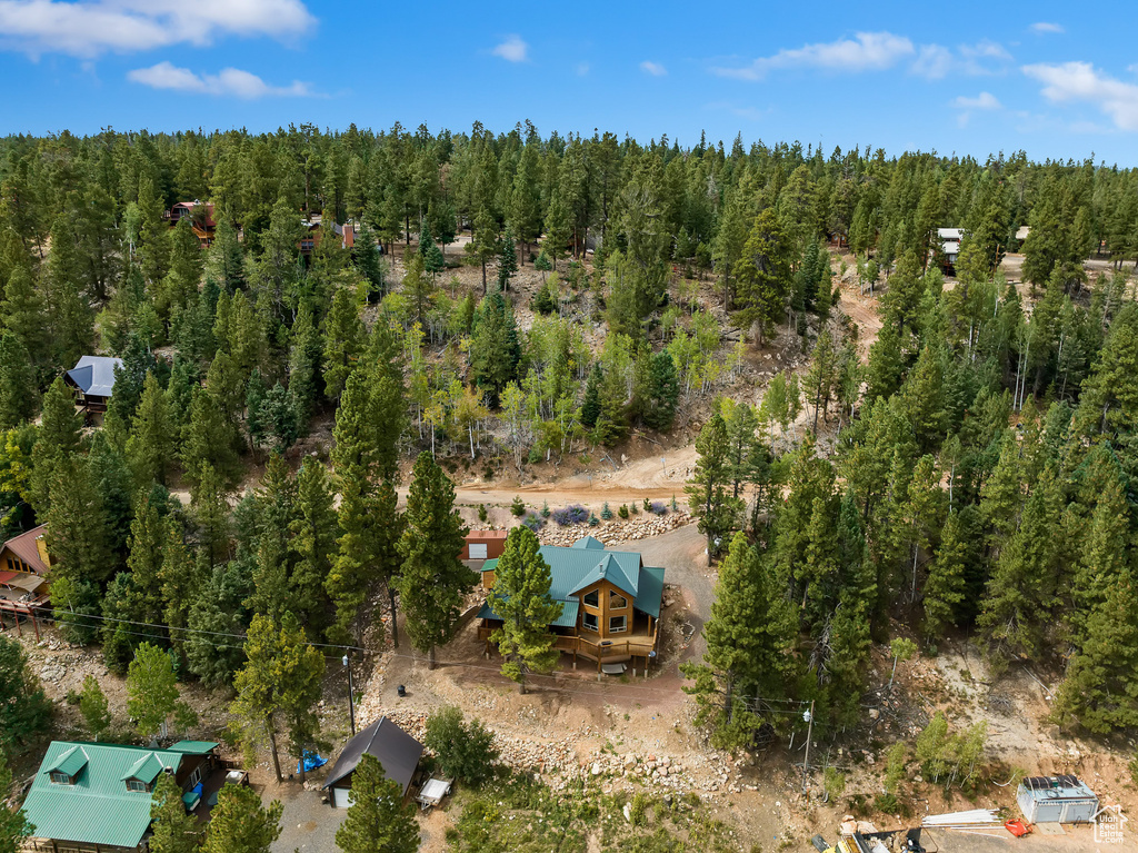 Birds eye view of property featuring a wooded view