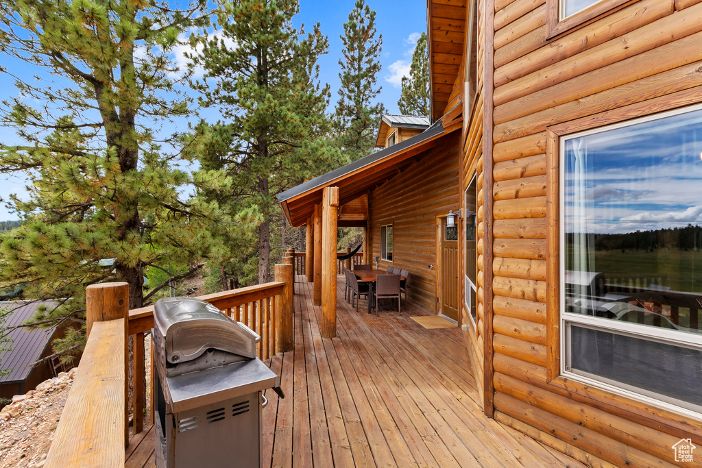 Deck featuring grilling area and outdoor dining space