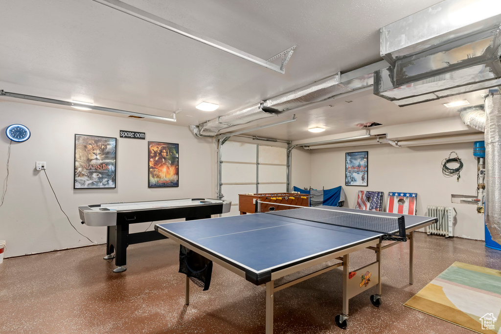 Game room with a garage and radiator