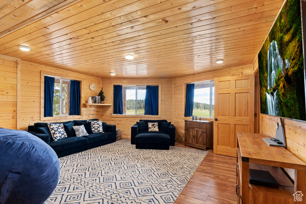 Living area with wooden ceiling, wood walls, and wood finished floors