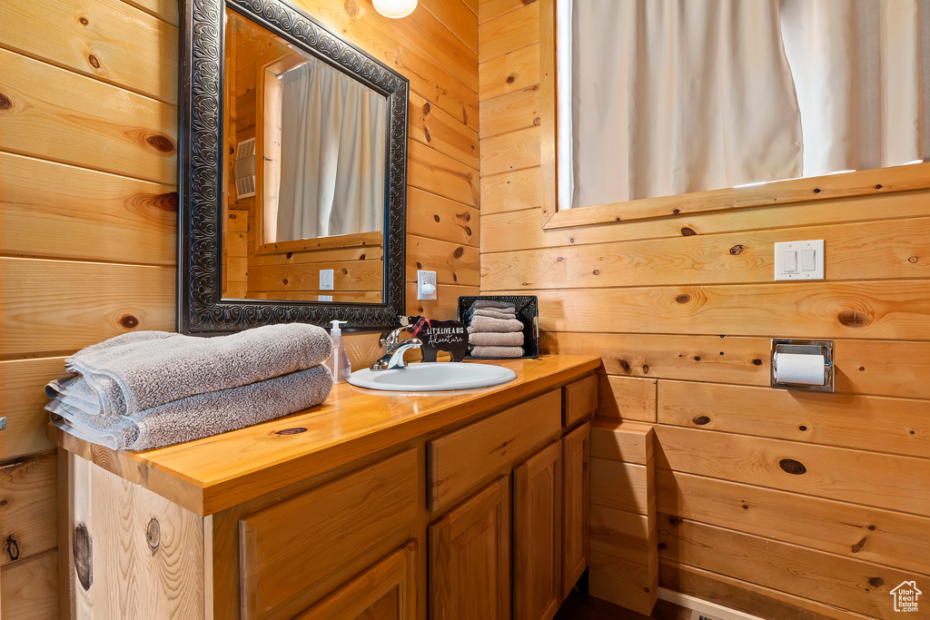 Bathroom with vanity and wooden walls