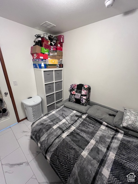 Bedroom featuring visible vents and marble finish floor