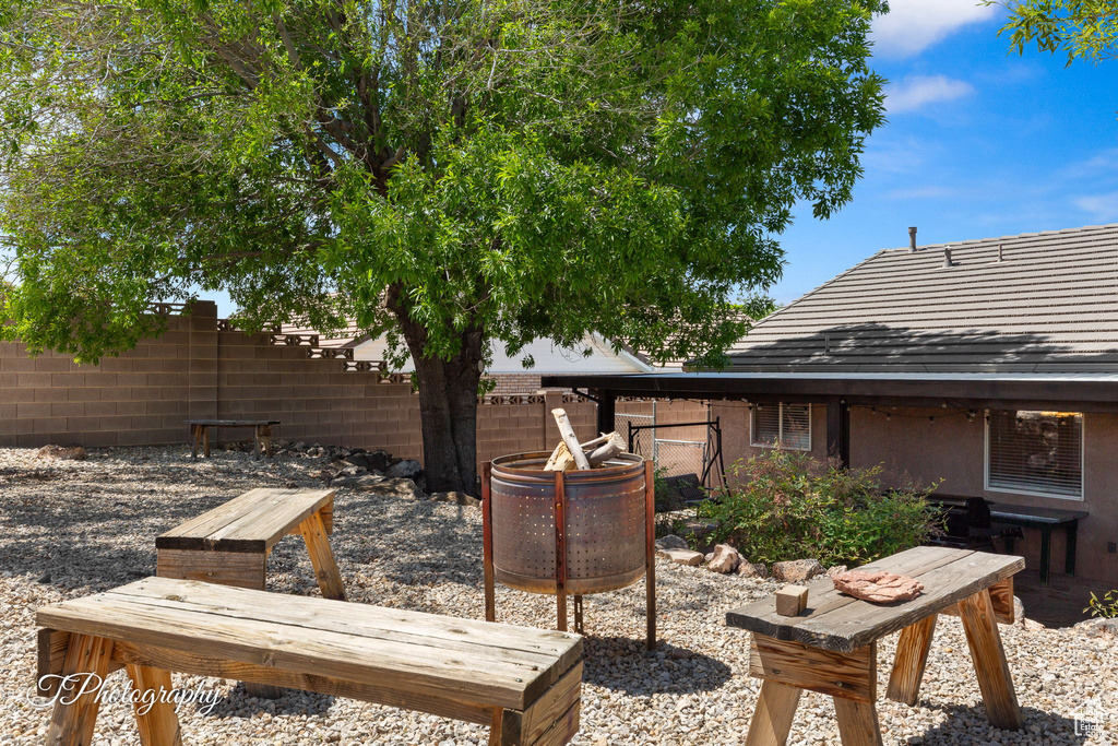 Exterior space with fence, a patio, and a fire pit