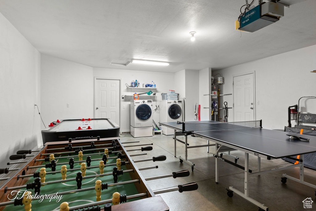 Playroom featuring water heater and washing machine and clothes dryer