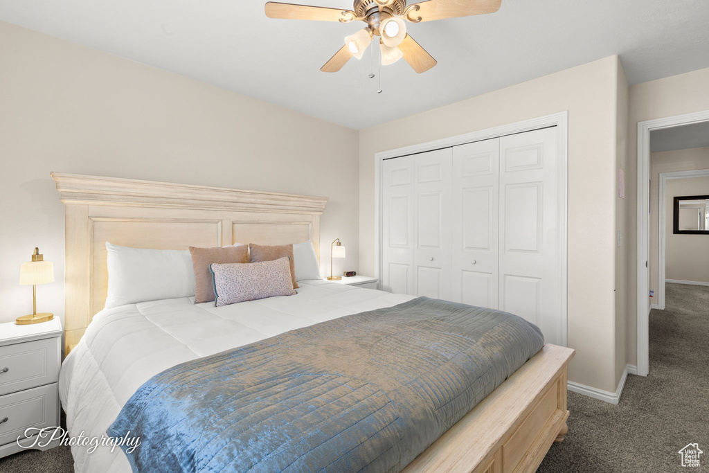 Carpeted bedroom featuring a closet, a ceiling fan, and baseboards