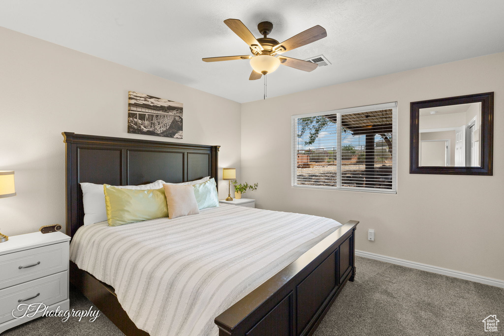 Bedroom with baseboards, carpet, ceiling fan, and visible vents