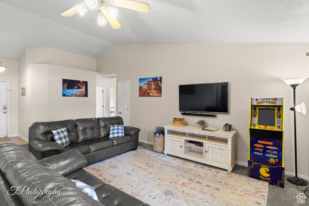 Living area featuring baseboards, ceiling fan, and lofted ceiling