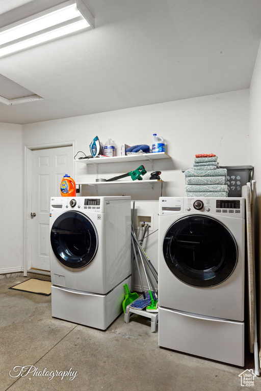 Laundry room featuring laundry area and washer and clothes dryer
