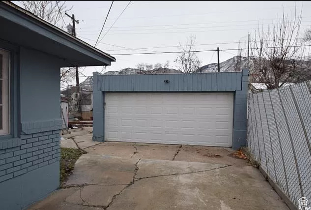 Detached garage featuring fence
