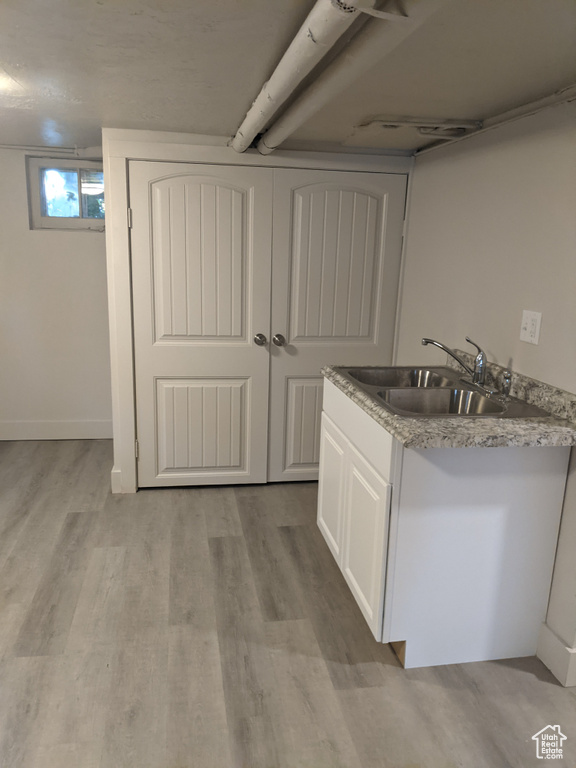Interior space featuring a sink and wood finished floors